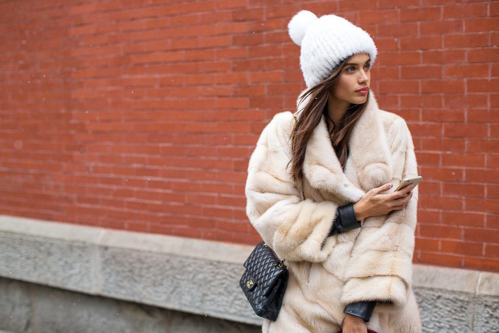 Textile, Brick, Street fashion, Headgear, Wool, Brickwork, Fur clothing, Fur, Beige, Natural material, 