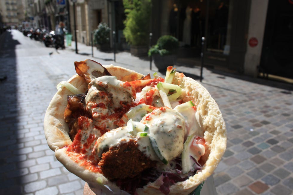 <p>Situated in the heart of Paris' Jewish Quarter on Rue de Rosiers, L'As du Fallafel houses some of the best falafel you'll ever eat outside of Israel. Don't be deterred by the long line out front and resist the temptation to choose one of the many imitation falafel joints on this street with a shorter line as an alternative. Here, the long line is undoubtedly worth the wait. Top your crispy concoction with roasted eggplant, creamy tahini,<span class="redactor-invisible-space"> an array of hot sauces (and even top with pommes frites if you're feeling indulgent!) for the perfect medley of mouth-watering flavors. We're not sure if you'll have room for dessert, but if you do, head down the block to <a href="http://finkelsztajn.com/" target="_blank">Sacha Finkelsztajn: La Boutique Jaune</a> for a Jewish pastry (they may just be the best homemade rugelach you'll ever taste.) Hint: for both of these eats, extra napkins are a must.</span></p><p><em><a href="http://www.yelp.com/biz/l-as-du-fallafel-paris" target="_blank">L'As du Fallafel</a><span class="redactor-invisible-space" style="line-height: 1.6em; background-color: initial;"><a href="http://www.yelp.com/biz/l-as-du-fallafel-paris"></a>, </span></em><em>Rue des Rosiers, 75004 Paris</em></p><p><em><a href="http://finkelsztajn.com/" target="_blank">Sacha Finkelsztajn: La Boutique Jaune</a>, Rue des Rosiers, 75004 Paris<br></em></p>