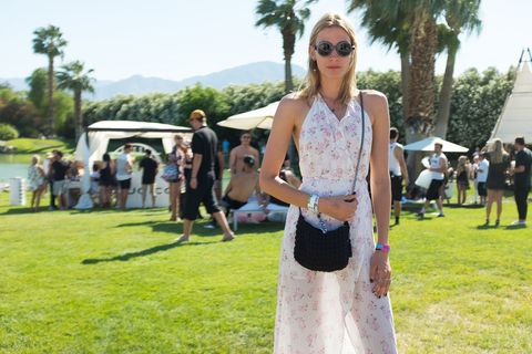 <p>This Coachella-goer brings femininity to the boho scene in a semi-sheer pink and white floral maxi dress.</p>