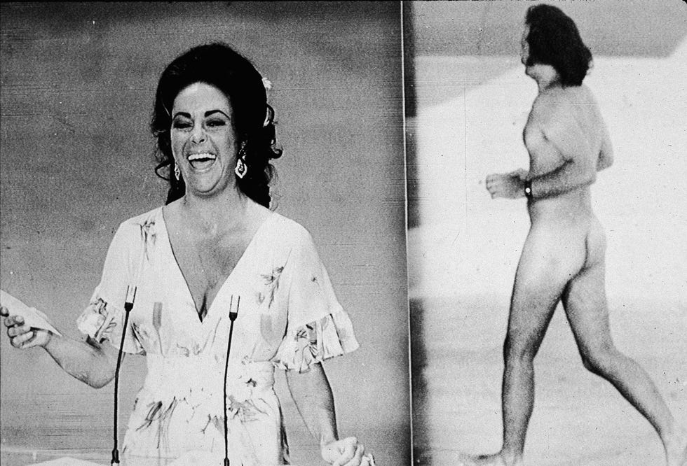 <p>As English actor David Niven introduces Elizabeth Taylor at the 46<sup>th</sup> Academy Awards, photographer and art gallerist Robert Opel streaks across the stage, flashing the audience a peace sign, among other things.</p>