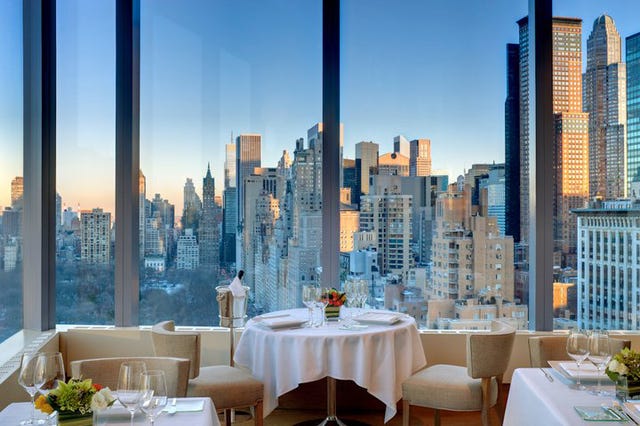 Tablecloth, Tower block, Real estate, Cityscape, Table, Furniture, Metropolitan area, Commercial building, Restaurant, Linens, 