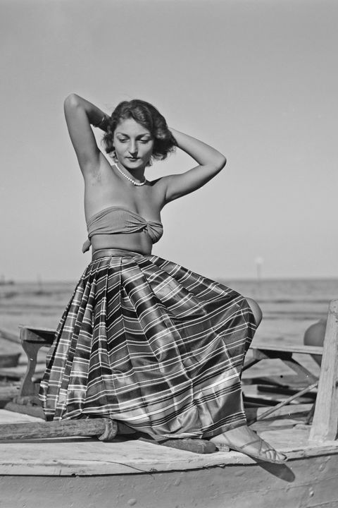 <p>Take the full circle skirt out of the 1950s housewife's kitchen and onto the beach by pairing it with a strapless bikini top and flat sandals.</p>
