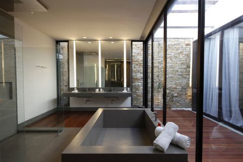 <p>The modern style of this penthouse makes a super-chic and sexy glass paneled bathroom feel right at home, and not overwrought.</p>