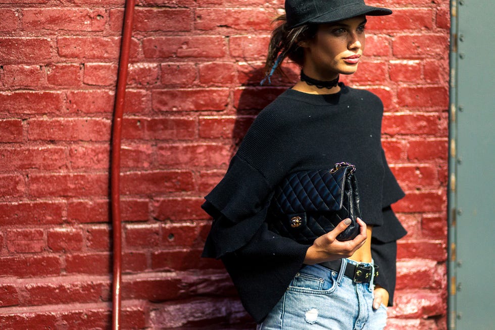 Brick, Sleeve, Shoulder, Hat, Denim, Red, Wall, Brickwork, Street fashion, Waist, 