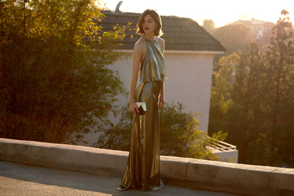 <p>Channel the glamour of 1970s&nbsp;Hollywood in a liquid-metal halter gown—a classic silhouette beloved for decades by cinema&nbsp;icons. You'll turn heads, steal hearts, and capture imaginations in this new take on a throwback.
</p><p><br>
</p><p><em data-redactor-tag="em" data-verified="redactor">Halston Heritage Metallic Jersey Halter Popover Gown, $895, <a href="http://www.neimanmarcus.com/Halston-Heritage-Metallic-Jersey-Halter-Popover-Gown-Antique-Brass/prod190920345/p.prod?icid=&amp;searchType=MAIN&amp;rte=%2Fsearch.jsp%3Ffrom%3DbrSearch%26request_type%3Dsearch%26search_type%3Dkeyword%26q%3Dhalston+heritage&amp;eItemId=prod190920345&amp;cmCat=search&amp;tc=334&amp;currentItemCount=250&amp;q=halston+heritage&amp;searchURL=/search.jsp%3Ffrom%3DbrSearch%26start%3D0%26rows%3D120%26q%3Dhalston+heritage%26l%3Dhalston+heritage%26request_type%3Dsearch%26search_type%3Dkeyword" target="_blank">neimanmarcus.com</a>; Rafe Maryanne Faceted Minaudiere, $745, <a href="http://www.neimanmarcus.com/Rafe-Maryanne-Faceted-Minaudiere-Blue-Multi-rafe-clutch/prod190920165___/p.prod?icid=&amp;searchType=MAIN&amp;rte=%252FeSearch.jsp%253FN%253D0%2526Ntt%253Drafe%252Bclutch%2526from%253DbrSearchExcep%2526_requestid%253D165227&amp;eItemId=prod190920165&amp;cmCat=search" target="_blank">neimanmarcus.com</a>; Zara Leather Slingback Loafers, $89.90, <a href="http://www.zara.com/us/en/woman/shoes/view-all/leather-slingback-loafers-c734142p3789511.html" target="_blank">zara.com</a>;&nbsp;H&amp;M Large Earrings, $6.99, </em><a href="http://www.hm.com/us/product/53963?article=53963-A" target="_blank"><em data-redactor-tag="em" data-verified="redactor">hm.com</em></a><br></p>