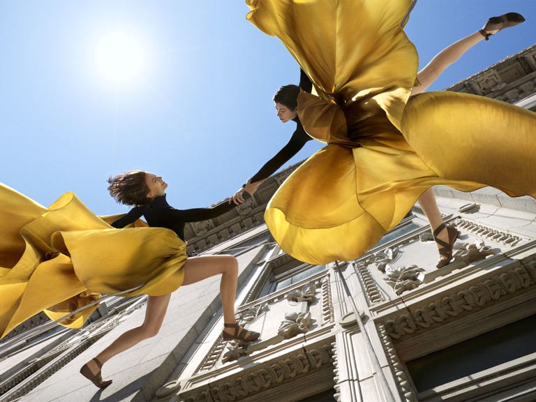 Yellow, Art, Fictional character, Sun, Sculpture, Angel, Wing, Lens flare, Costume, Supernatural creature, 