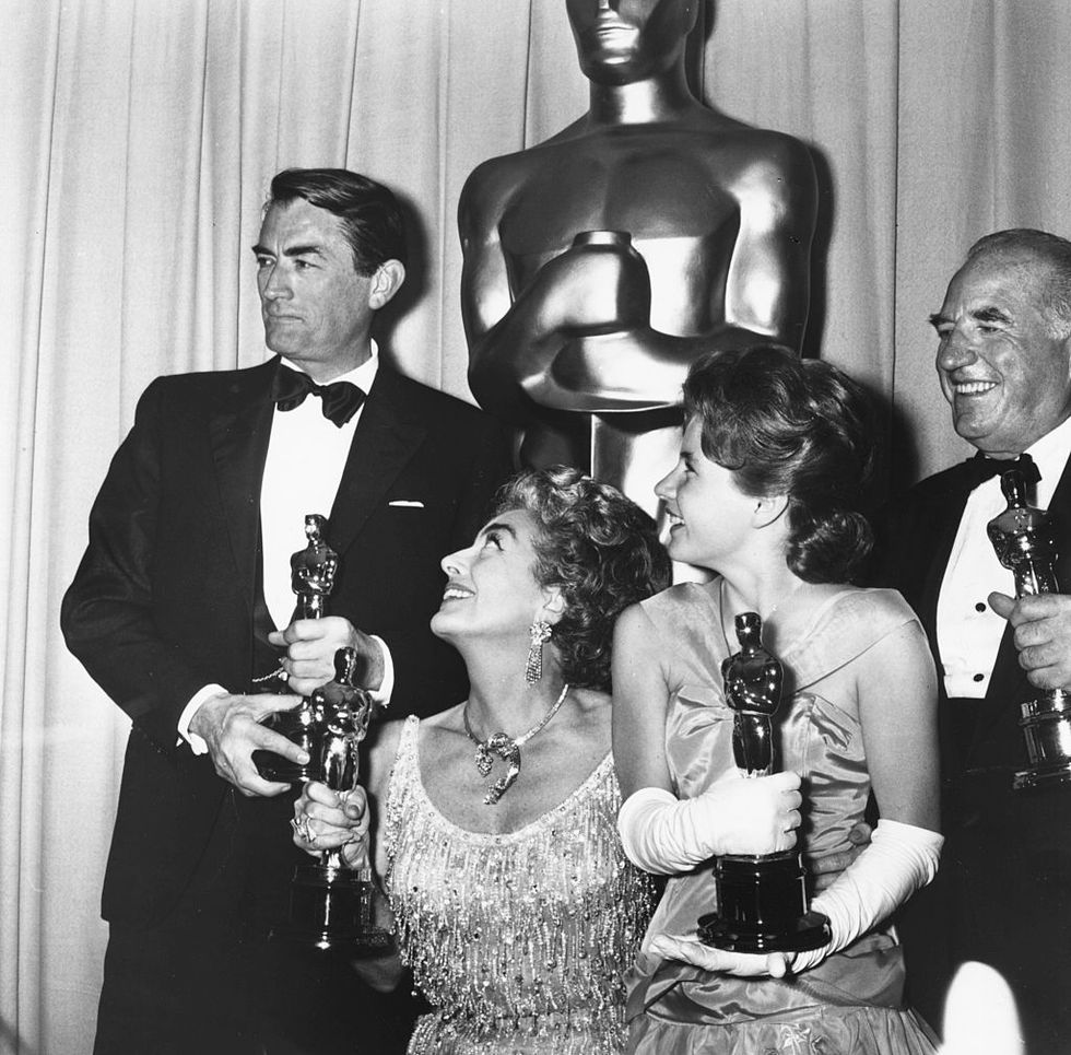 Joan Crawford (accepting for Anne Bancroft) with Gregory Peck, Patty Duke And Ed Begley with their Oscars, at the 35th Academy Awards.