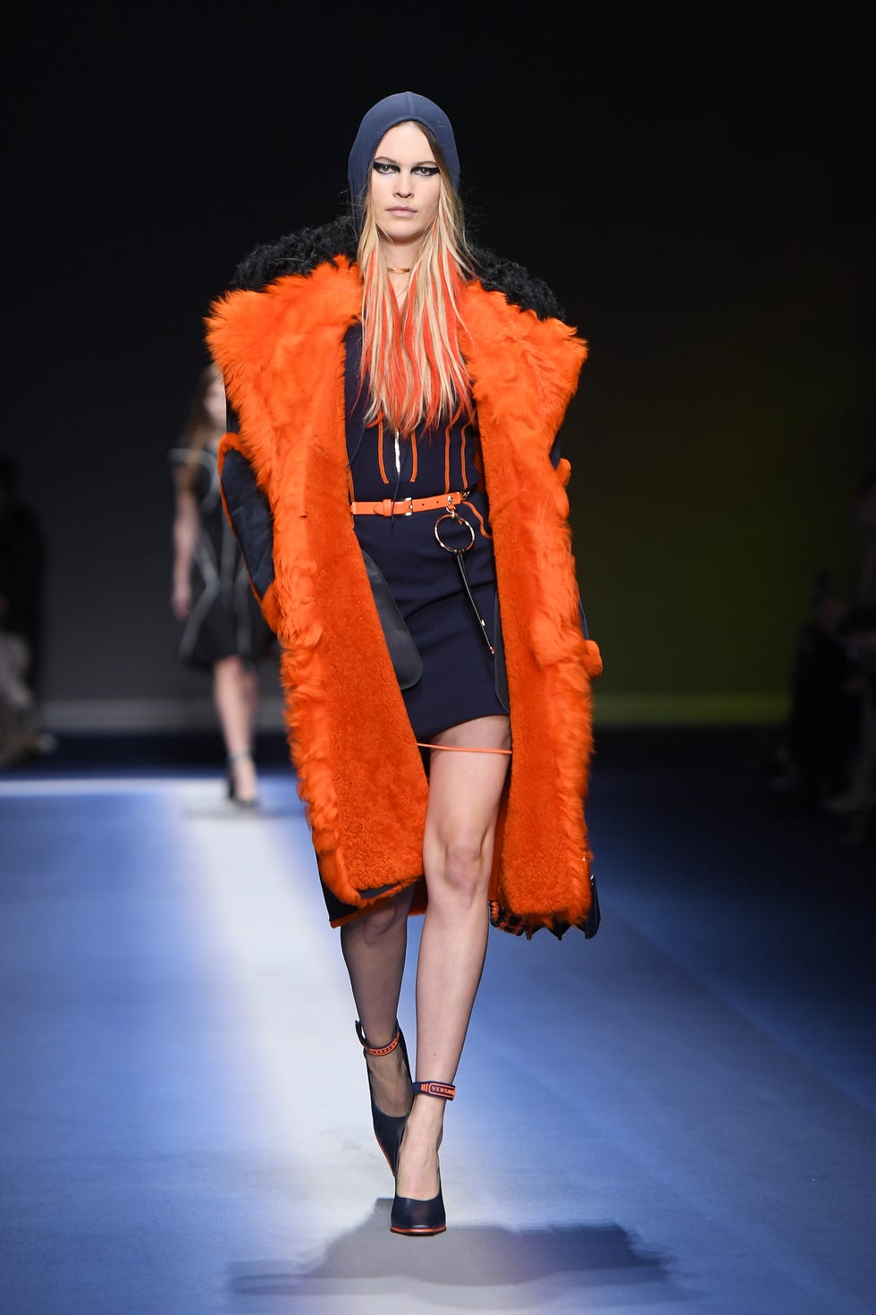 Fashion show, Event, Shoulder, Human leg, Runway, Style, Fashion model, Dress, Orange, High heels, 