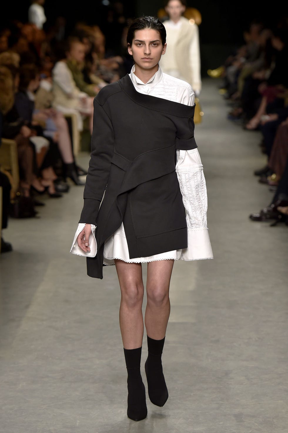 Clothing, Leg, Fashion show, Event, Shoulder, Human leg, Joint, Runway, Outerwear, Fashion model, 