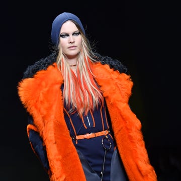 Fur clothing, Orange, Costume design, Fashion model, Electric blue, Fur, Animal product, Beanie, Street fashion, Costume, 