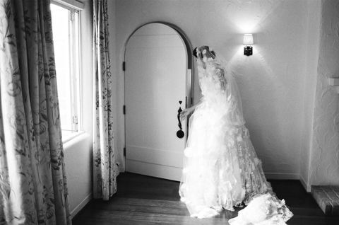 Photograph, White, Dress, Wedding dress, Gown, Bride, Bridal clothing, Black-and-white, Room, Bridal accessory, 