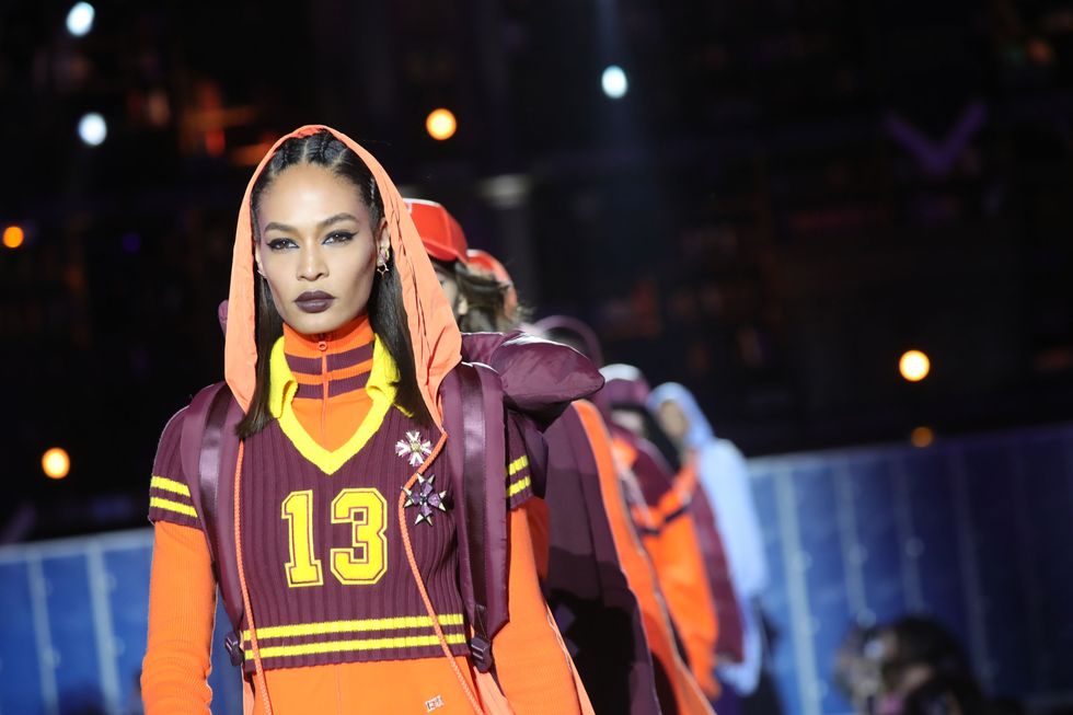 <p>The perfect combination: Joan Smalls, half-up cornrows, moody purple lipstick, and a hooded ensemble from Rihanna's Fenty collection.</p>