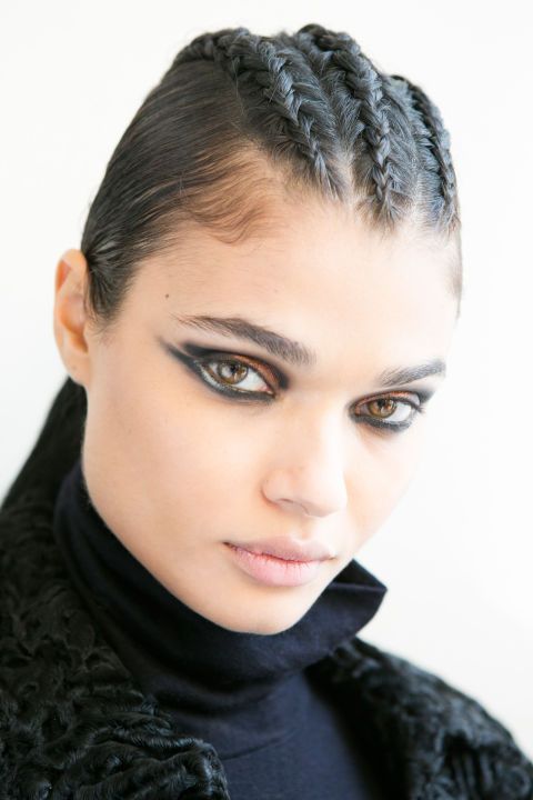 <p>For Balmain this season, hairstylist Sam McKnight braided three or four cornrows along the center of the head ("in an imaginary mohawk," he said), then pulled the hair back into a tight ponytail. Extensions were added for length, so that the tails reached the middle of the models' backs. A root cover-up powder in shade darker than the models' hair was used along the braids to cover the skin, and then McKnight's namesake styling products (launching later this year) added the grit and hold needed to keep the look in place. "She's tougher and more warrior-like than in the past," said the hairstylist.&nbsp;<span class="redactor-invisible-space"></span></p>