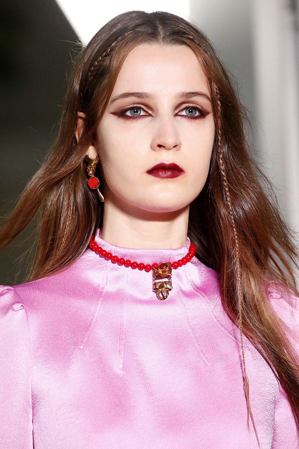 <p>There was a lot more look to be served up this season at Valentino compared to seasons past. Instead of a long, romantic braid—the hair was parted down the middle, and two micro braids were weaved along the hairline.&nbsp;<span class="redactor-invisible-space"></span></p>