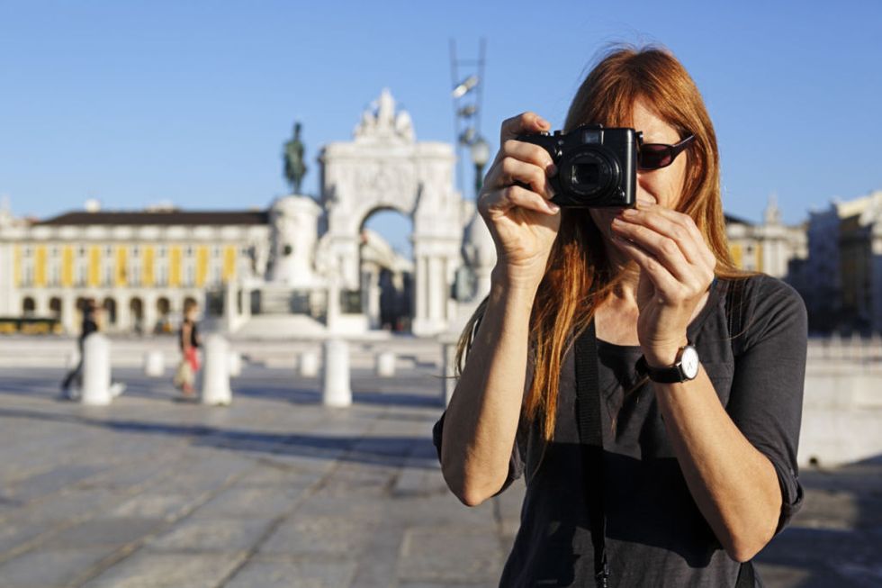 woman tourist taking camera photo