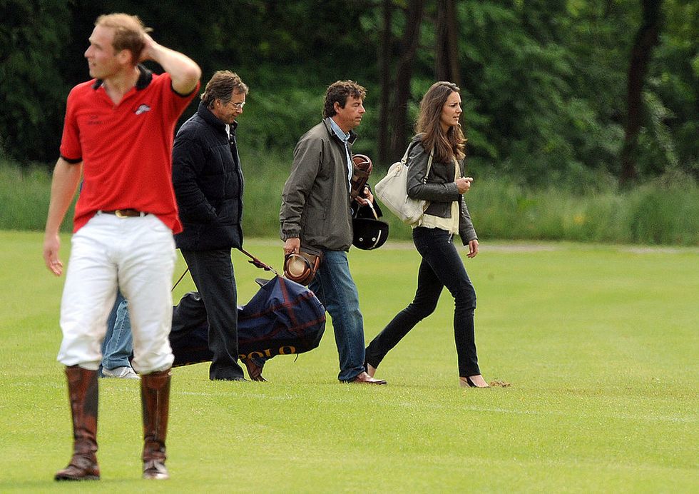 Prince William looks puzzled as Kate Middleton walks past during a charity polo match at Cirencester Park Polo Club on June 7, 2009 in Cirencester, England.