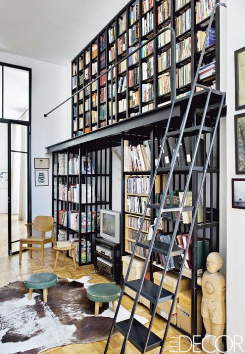 <p>Laureen Rossouw, editor of <em>ELLE Decoration South Africa</em>, devised a double-height metal shelving unit for the study of her Cape Town apartment. The 1950s stools and chair were purchased at local antiques shops.</p>