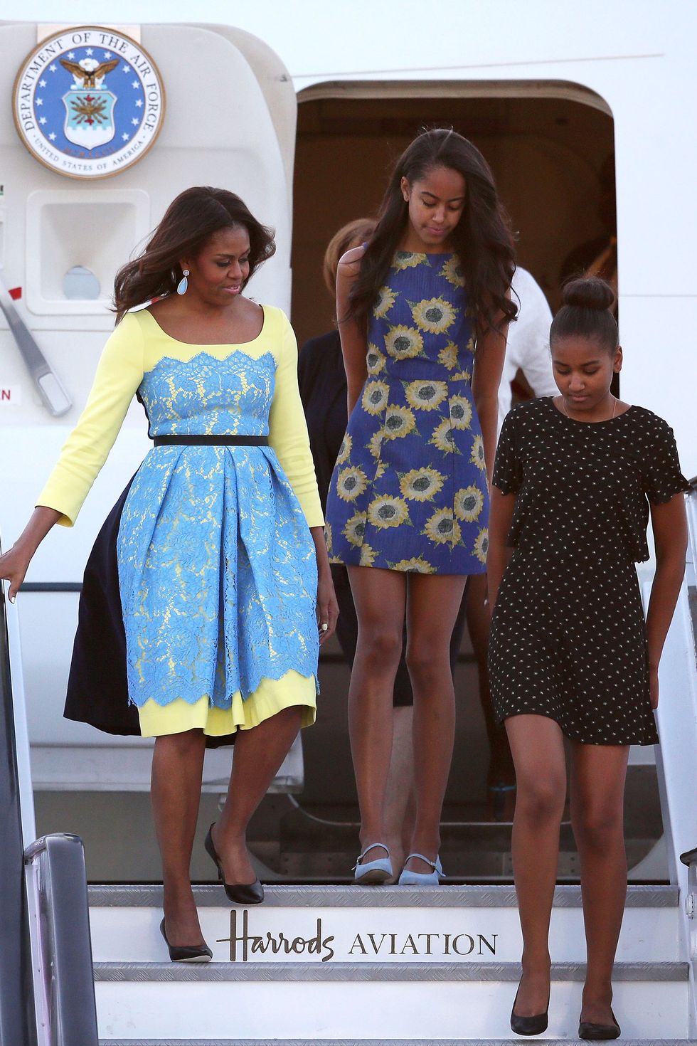 LONDON, ENGLAND - JUNE 15:  First Lady Michelle Obama arrives with daughters Malia Obama (C) and Sasha Obama (R) at Stanstead airport on June 15, 2015 in London, England. The First Lady is travelling to London with her daughters, Malia and Sasha and her mother, Mrs. Marian Robinson, to continue a global tour promoting her Let Girls Learn Initiative.† During the visit she will meet with students at a girl's school to discuss how the UK and U.S. are working together to expand girl's education around the world.  (Photo by Dan Kitwood/Getty Images)