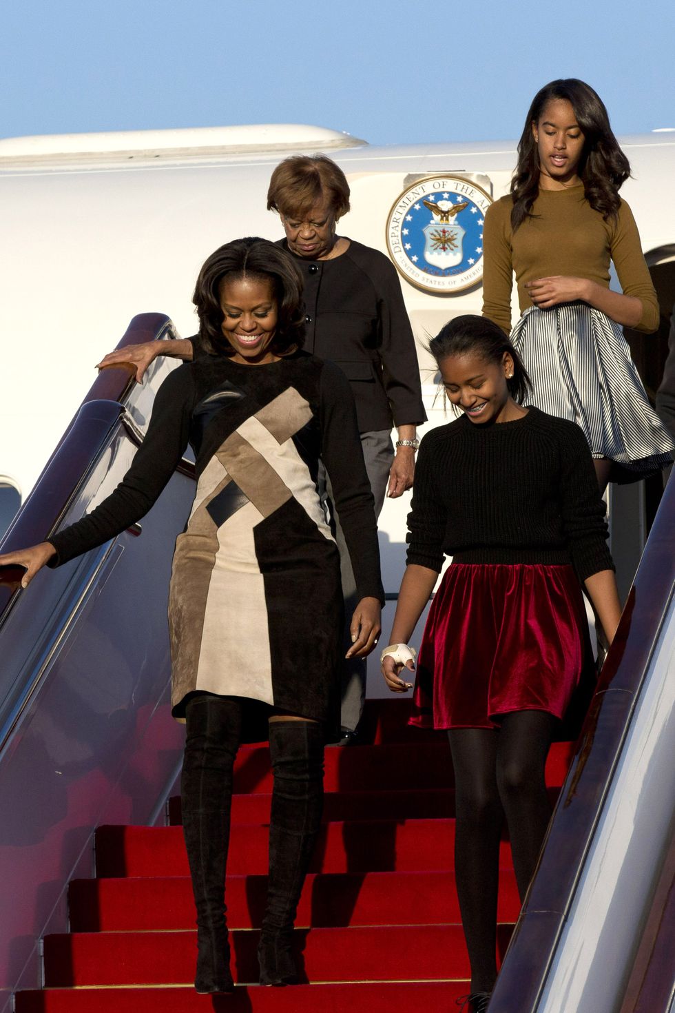 BEIJING, CHINA - MARCH 20:  First Lady Michelle Obama with her mother Marian Robinson, daughters Sasha Obama and Malia Obama arrives at Beijing Capital International Airport on March 20, 2014 in Beijing, China. The first lady arrived in Beijing with her mother, Marian Robinson, and daughters to kick off a six-day tour where she will focus on education and cultural exchange. (Photo by Alexander F. Yuan - Pool /Getty Images)