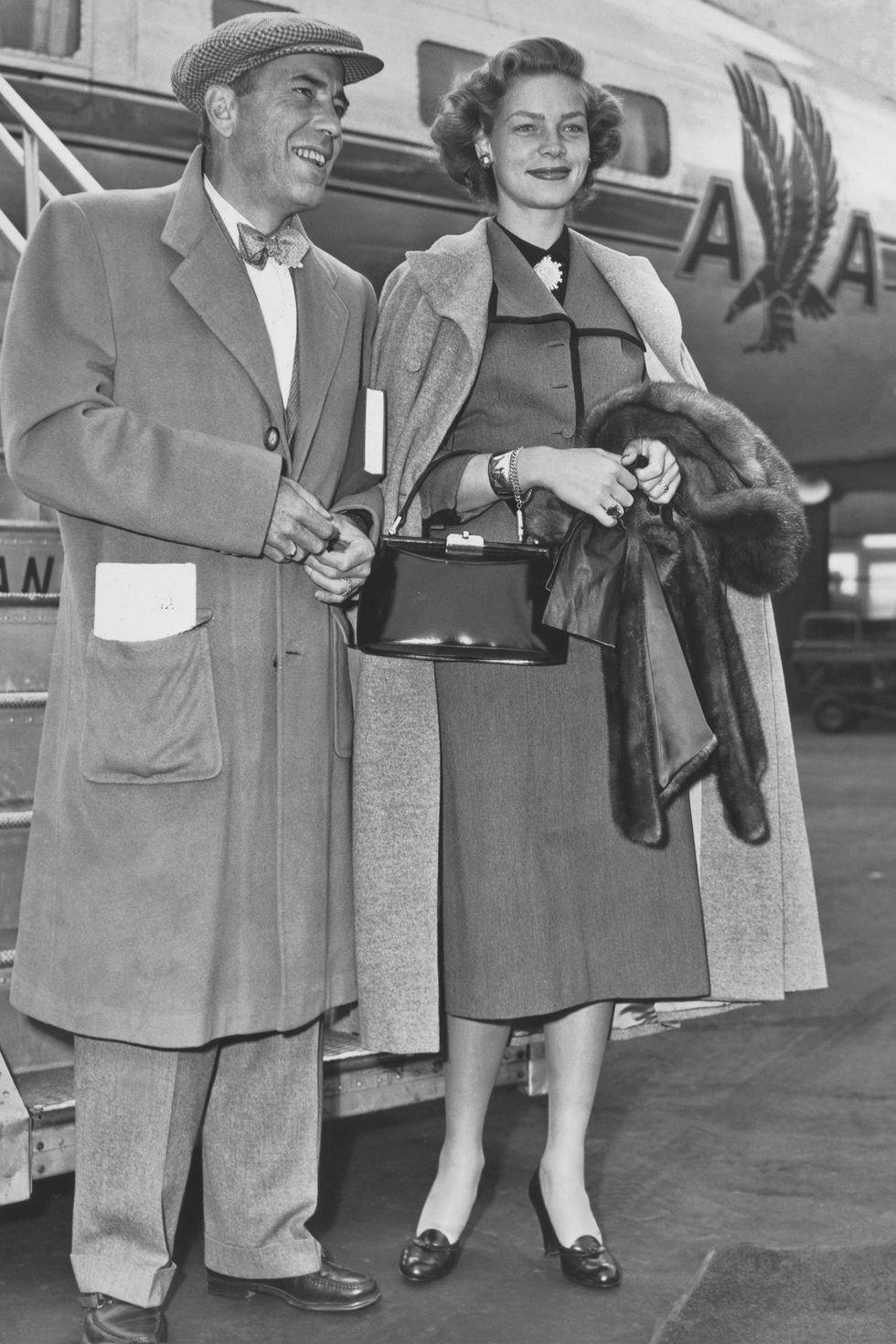 American actor Humphrey Bogart (1899 – 1957) with wife actress Lauren Bacall on the tarmac at La Guardia airport, New York on October 13, 1950. They were in New York to appear in the Theatre Guild's production of 'Farewell to Arms'. (Photo by Pictorial Parade/Archive Photos/Getty Images)