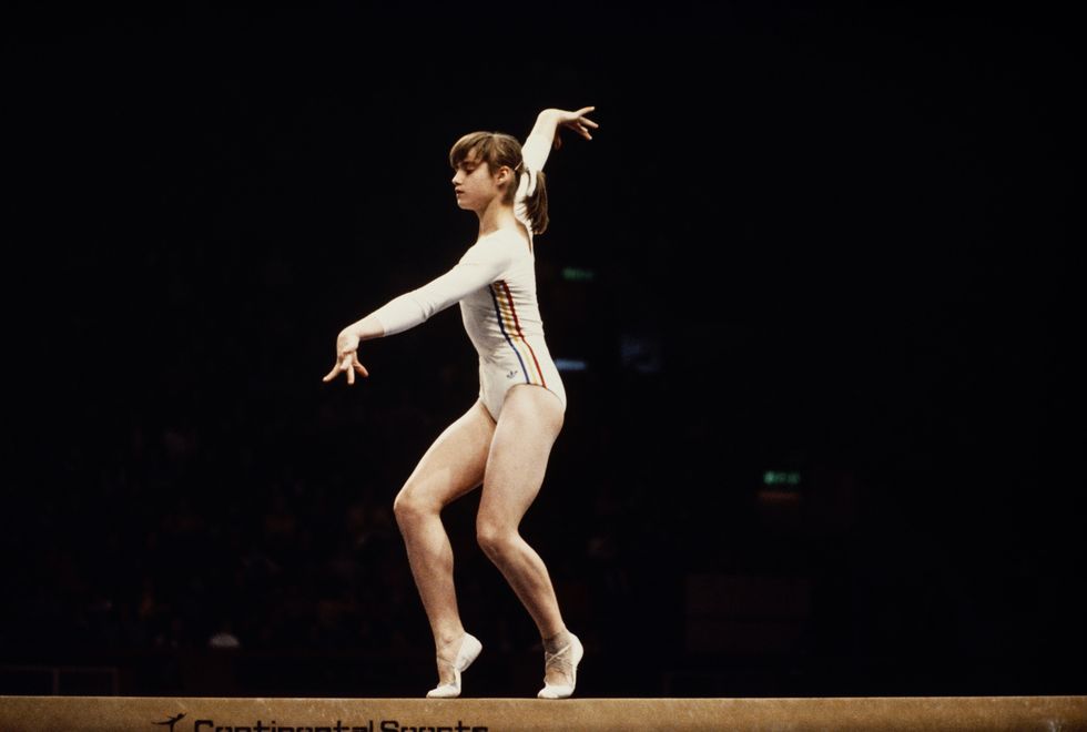 <p>Romanian Nadia Comenci truly stole the show during the 1976 Olympics—she was awarded the first perfect 10.0 score ever in the Games and then proceeded to get an insane *seven more* perfect 10's during the competition. At the same time, ponytails also made their play during the '76 games, and have become a staple ever since. The slicked-back style clearly makes the most sense for competitors, but up until the '70s, athletes were still abiding by "ladylike" styles while they competed—thankfully the freedom of the '70s also ushered in more sensible competition styles. </p>