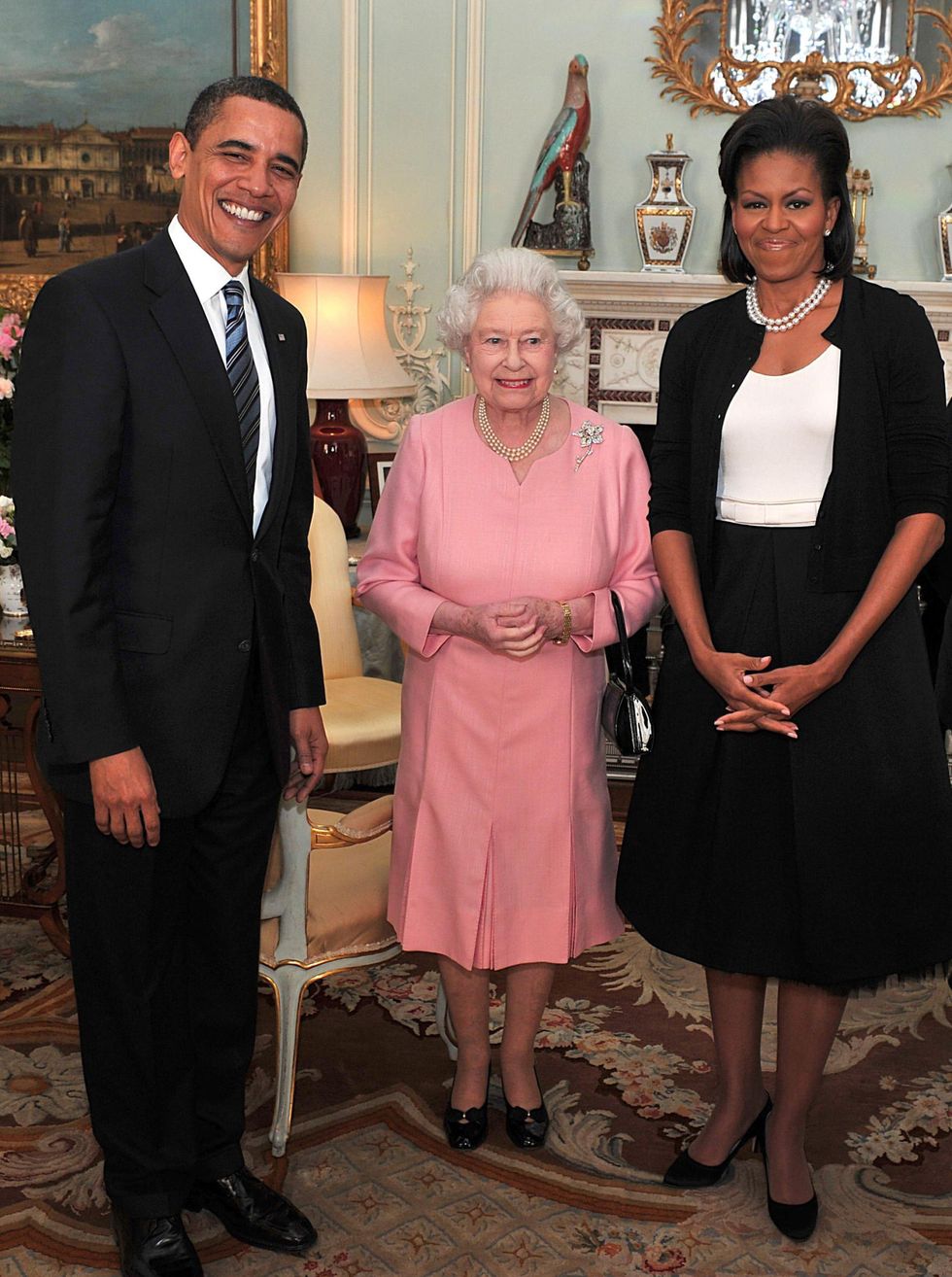 <p><strong data-verified="redactor" data-redactor-tag="strong">When: </strong>April 1, 2009</p>

<p><strong data-verified="redactor" data-redactor-tag="strong">Where: </strong>With Queen Elizabeth II at a Buckingham Palace reception in London</p>

<p><strong data-verified="redactor" data-redactor-tag="strong">Wearing: </strong>Isabel Toledo dress, Alaïa cashmere cardigan, double stranded pearls</p>

<p><strong data-verified="redactor" data-redactor-tag="strong"></strong><strong data-verified="redactor" data-redactor-tag="strong">Why it mattered: </strong>On that same trip to London, Michelle met the Queen—in her signature cardigan. Not everyone was a fan: At the time Oscar de la Renta told <a href="http://www.wwd.com/fashion-news/major-designers-wait-for-first-ladys-call-2090453?src=bblast/040309">Women's Wear Daily</a>, "You don't...go to Buckingham Palace in a sweater." (Coincidence? The First Lady didn't wear Oscar de la Renta until 2014, shortly before the designer passed away.) Dincuff hails this as yet another example of Michelle's ability to represent the average American woman—in a chic and elegant way. "I think the whole idea of wearing a sweater instead of a jacket is very American," she says. "She's the epitome of what a modern American working mother wants to look like and she stayed true to that look and to herself, even at very high-profile appearances."</p>