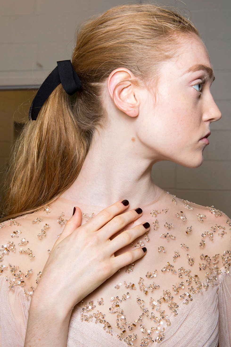 <p>At Monique Lhuillier's spring 2017 show, hairstylist Bob Recine pulled the hair back into a ponytail right in the middle of the head—it wasn't too high or too low. The elastics were covered with a jumble of black ribbon to add a little bit of polish (the models were wearing gowns, after all). But they weren't weren't fluffed or knotted in a perfect bow; this is the cool-girl's take on a classic ponytail.</p>
