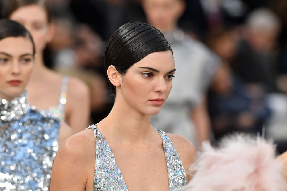 <p>At Chanel couture, the models walked the runway in show-stopping&nbsp;embellished silver gowns. There was enough glitz to distract you from perhaps the biggest news of the day: the models all walked with a smattering of silver glitter highlighter along their upper cheekbones. It's safe to say the glitter and highlighter trends aren't going anywhere.</p>