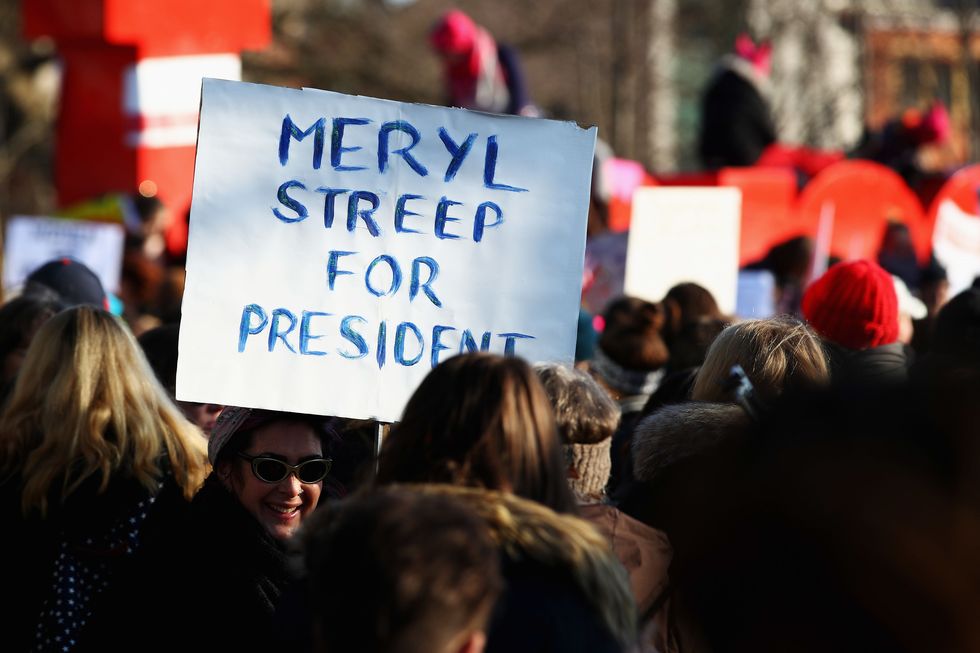 AMSTERDAM, NETHERLANDS - JANUARY 21:  Demonstrators with a sign saying " Meryl Streep for President " make their way from the iamsterdam statue in front of the Rijksmuseum towards US Consulate during the Women's March held at Museumplein on January 21, 2017 in Amsterdam, Netherlands.  The Women's March originated in Washington DC but soon spread to be a global march calling on all concerned citizens to stand up for equality, diversity and inclusion and for women's rights to be recognised around the world as human rights. Global marches are now being held, on the same day, across seven continents.  (Photo by Dean Mouhtaropoulos/Getty Images)