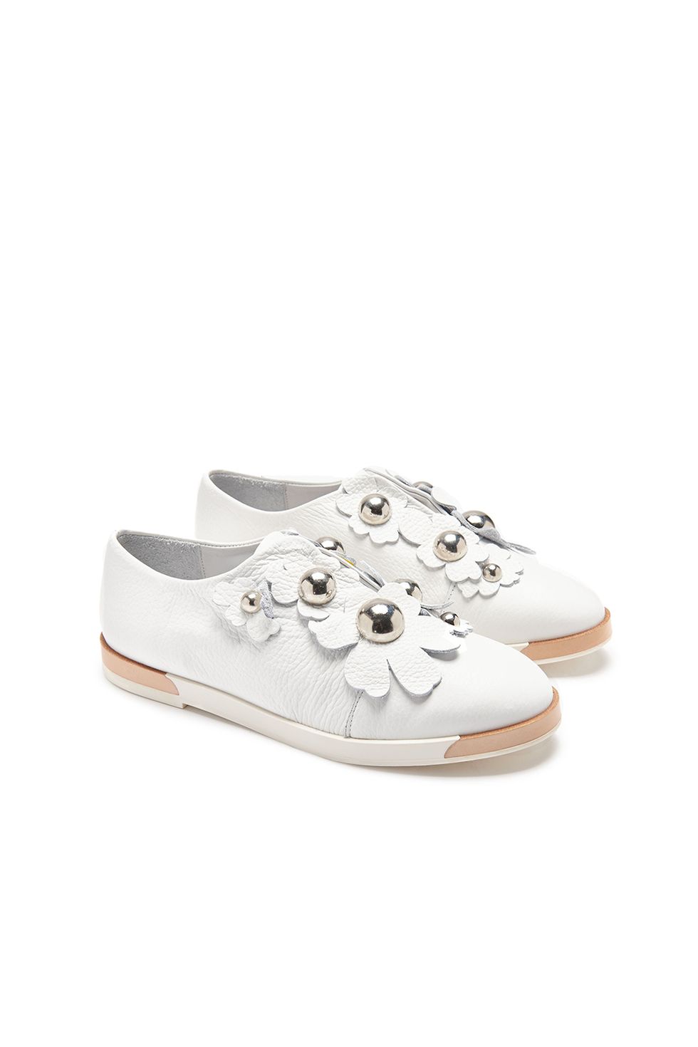 <p>The latest in beautiful white sneakers (which are definitely worth the perpetual dirt dilemma)&nbsp;are topped with summery white florals.&nbsp;</p><p><strong data-redactor-tag="strong" data-verified="redactor">Blanche White Slip-Ons, $295; <a href="https://usa.miista.com/collections/flats/products/blanche-white-flats" target="_blank" data-tracking-id="recirc-text-link">miista.com</a>.</strong></p>