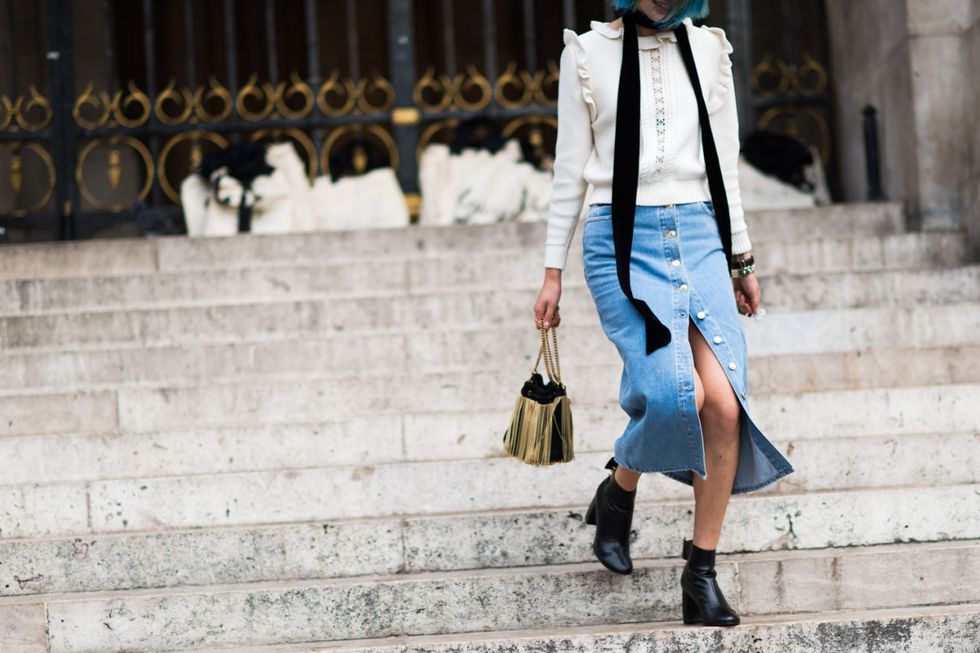<p>A Victorian-inspired blouse worn with denim is an unexpected, but awesome combination for spring. DIY a slit on bottom by undoing a few of the buttons on your skirt. </p>