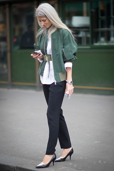 <p>下身的西裝褲及黑白尖頭低跟鞋，正式具都會感，搭上一件綠色夾克為整體中和了正式感，夾克本身的腰帶很有特色，不對稱的繫在腰上，兼具了街頭帥氣的味道。</p>