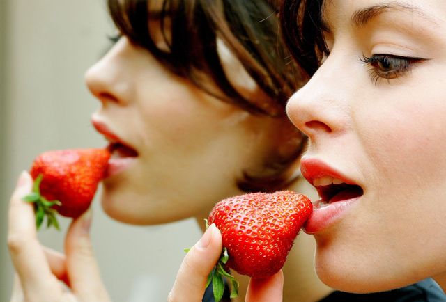 women eat strawberry