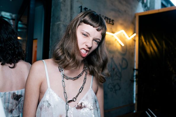 Mouth, Jewellery, Black hair, Neck, Necklace, Chest, Sleeveless shirt, Flash photography, Body jewelry, Street fashion, 