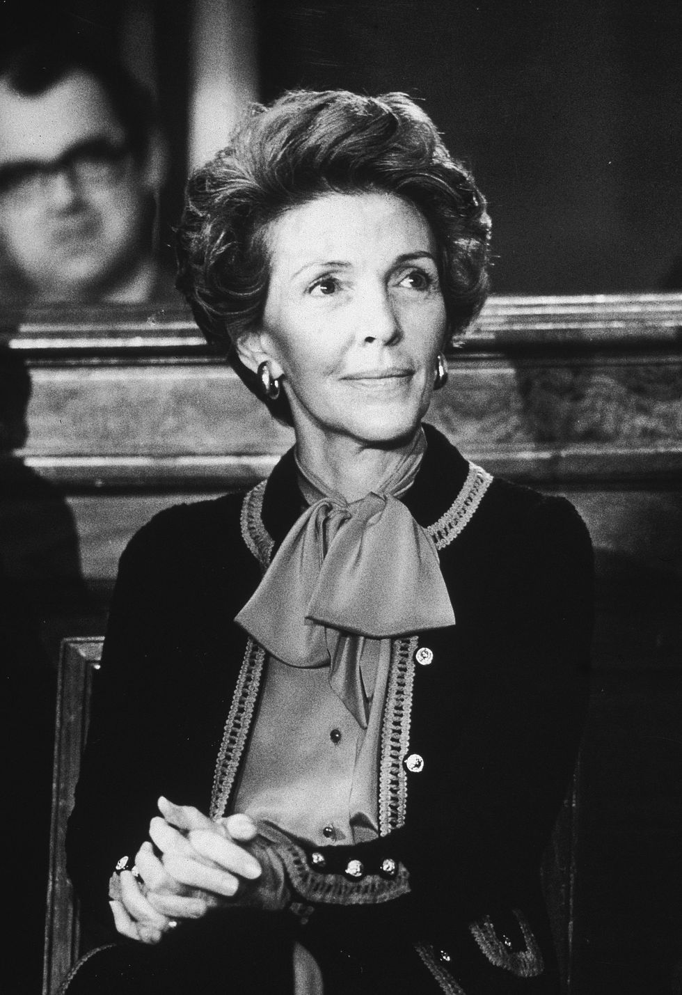 Nancy Reagan, wife of California governor Ronald Reagan, sits with her hands clasped on her knee at the Governor's Press Conference in the Senate Office Building, November 14, 1979. (Photo by Hulton Archive/Getty Images)