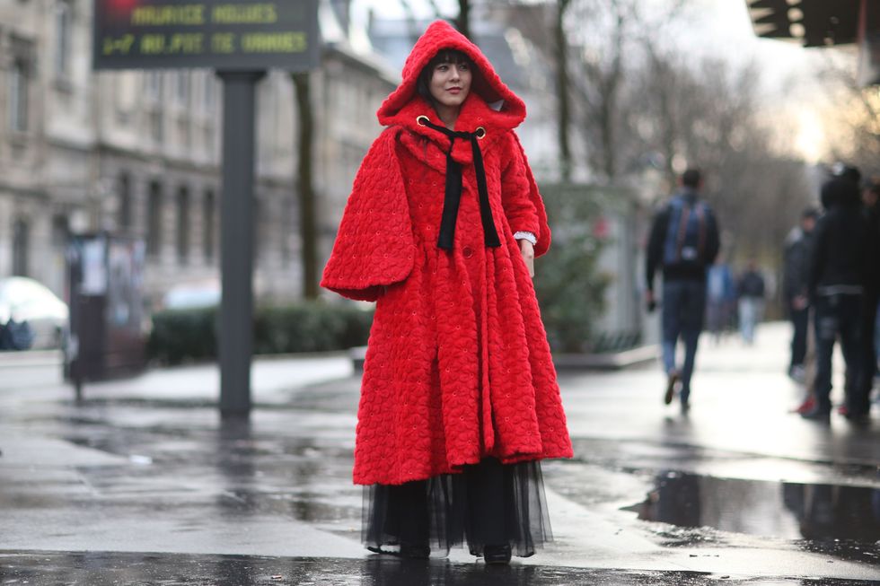 Red, Street fashion, Outerwear, Clothing, Standing, Fashion, Rain, Pedestrian, Street, Headgear, 