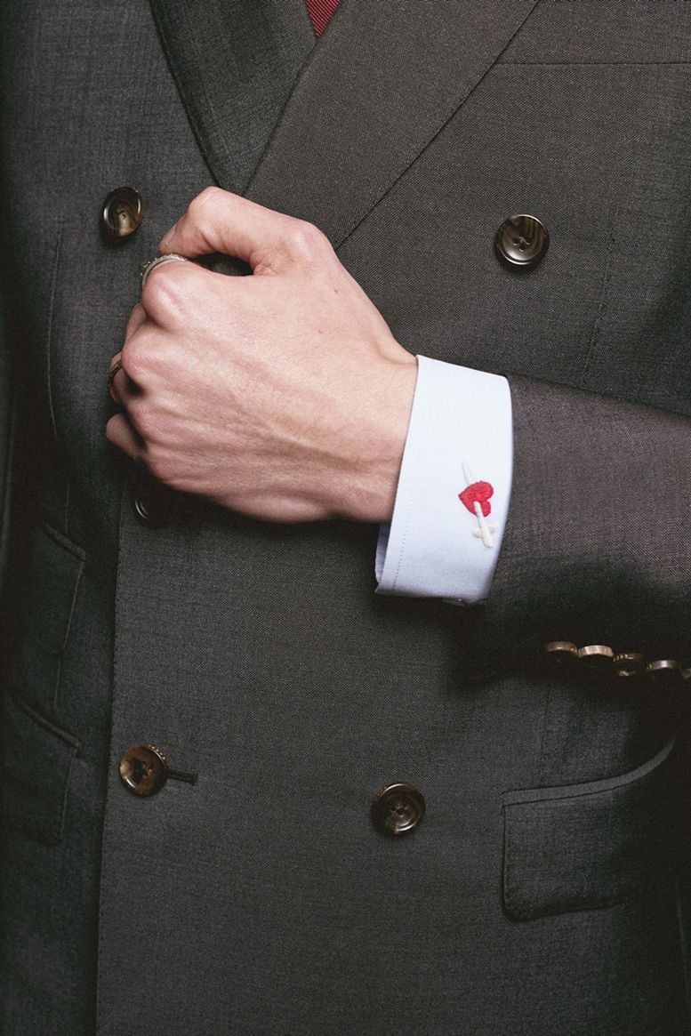 Button, Suit, Formal wear, Outerwear, Blazer, Pocket, Hand, Jacket, Gesture, Fashion accessory, 