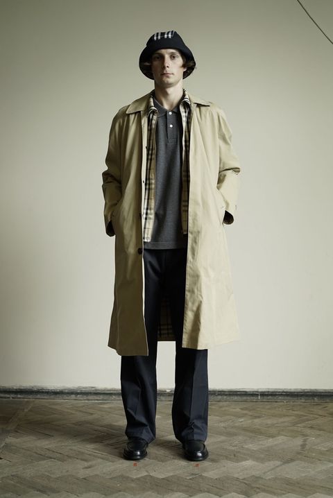 Clothing, Trench coat, Fashion, Outerwear, Standing, Coat, Human, Overcoat, Fashion design, Headgear, 