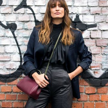 Brick, Wall, Brickwork, Street fashion, Glove, Long hair, Leather, Belt, Graffiti, Photo shoot, 