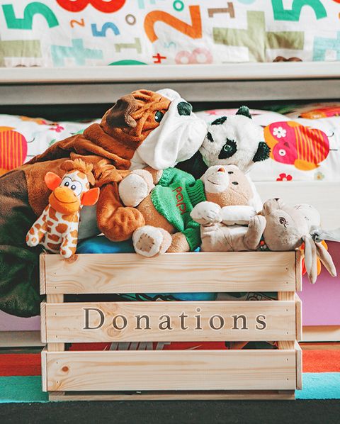 wooden donation box filled with stuffed animals