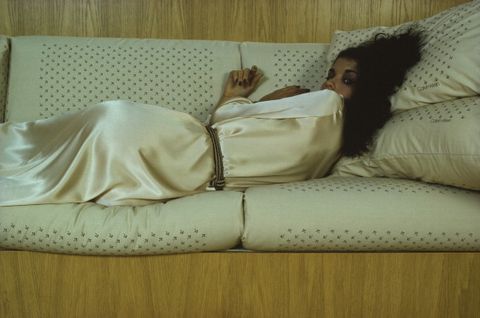 portrait of american model janice dickerson, dressed in a silk gown, as she lies on a sofa and looks over her shoulder, amagansett, new york, october 1978 the photo was taken as part of an ad campaign shoot for wamsutta sheets, featuring calvin klein designs it was taken in a house in the hamptons designed by gwathmey and siegel architects photo by susan woodgetty images