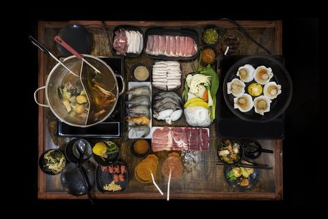 top view of shabu set on table with hot pot and hot pan in dinner table