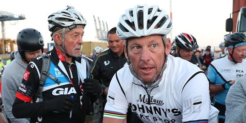 Lance Armstrong rides with fans in Auckland, New Zealand, in December 2016.