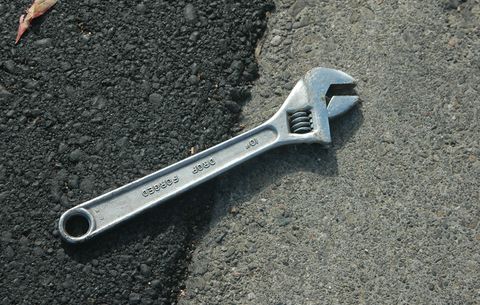 a wrench on asphalt