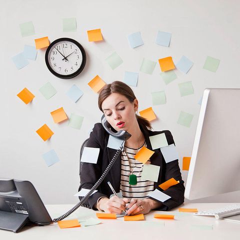 woman with too many post-it notes