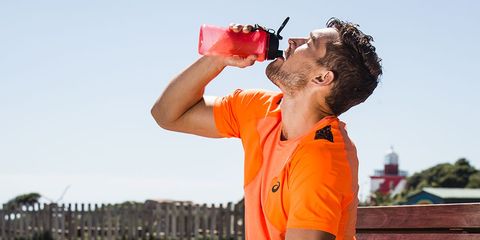man drinking from sports bottle