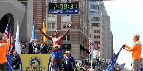Meb crossing finish line 2014 Boston Marathon