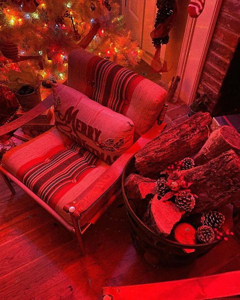 Gigi Hadid's Christmas decor, including tree and stockings, washed in red light
