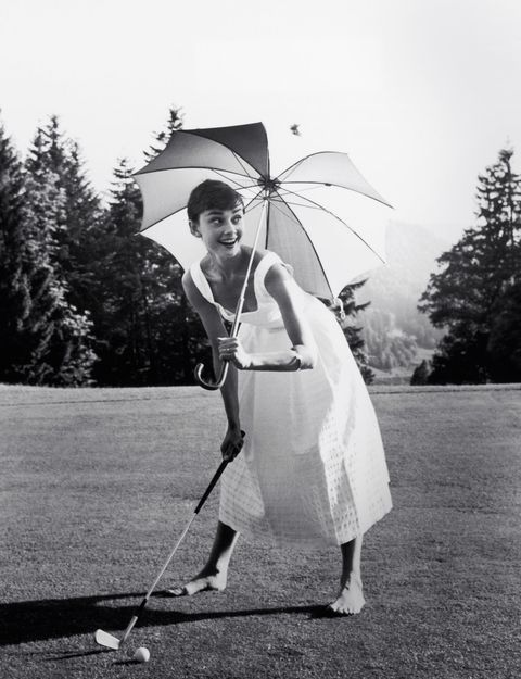pmc49y audrey hepburn playing golf and holding a parasol, circa 1955 file reference  33536275tha