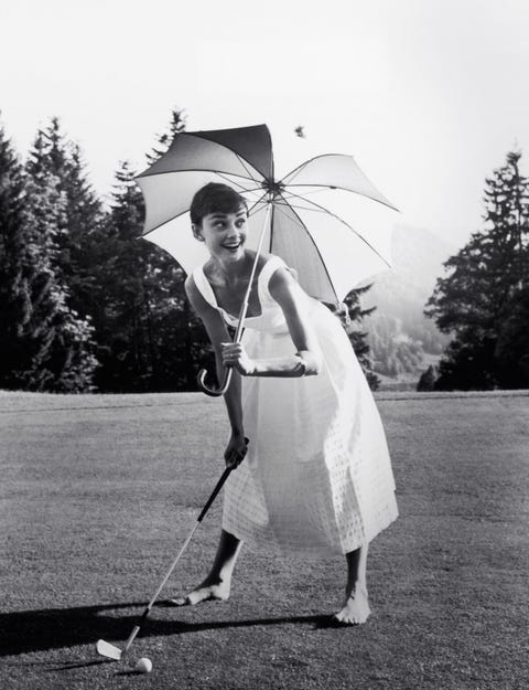 Audrey Hepburn playing golf and holding a parasol, circa 1955 File Reference # 33536_275THA pmc49y audrey hepburn playing golf and holding a parasol, circa 1955 file reference 33536275tha